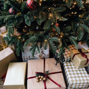 christmas gift boxes under fir tree