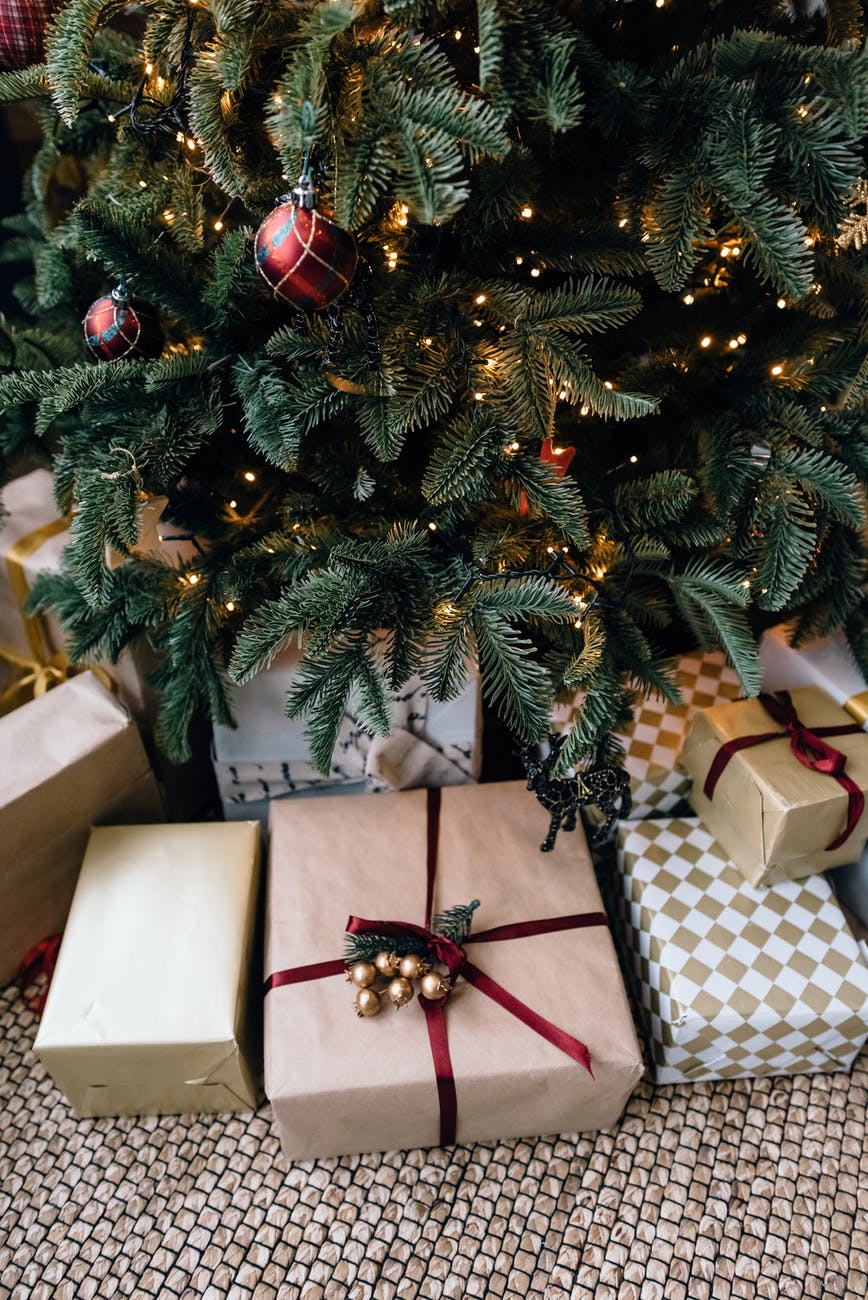 christmas gift boxes under fir tree