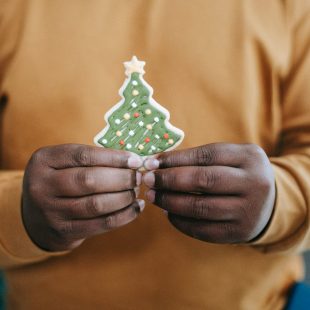 black man with gingerbread in form of christmas tree